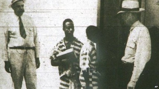 George Stinney,  center, with white prison guards